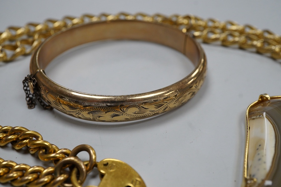 A group of gilt metal / pinchbeck jewels and an Arts & Crafts brooch by William Hair Haseler, comprising: a hinged bangle; an enamelled pendant in the Egyptian revival style; a gold curb link bracelet with a heart-shaped